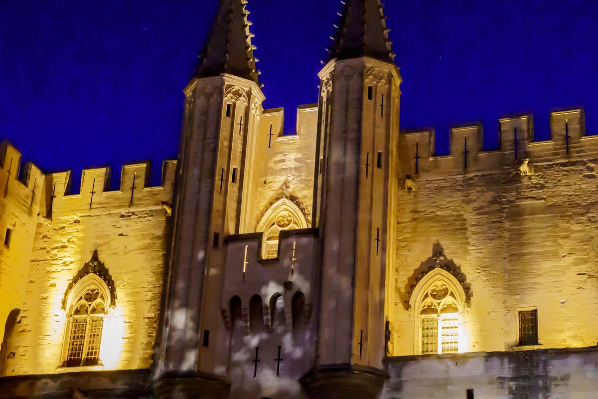 The Palais des Papes lit up at night in Avignon, France