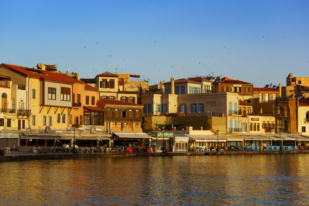 Chania's Venetian harbor glowing gold in the evening light
