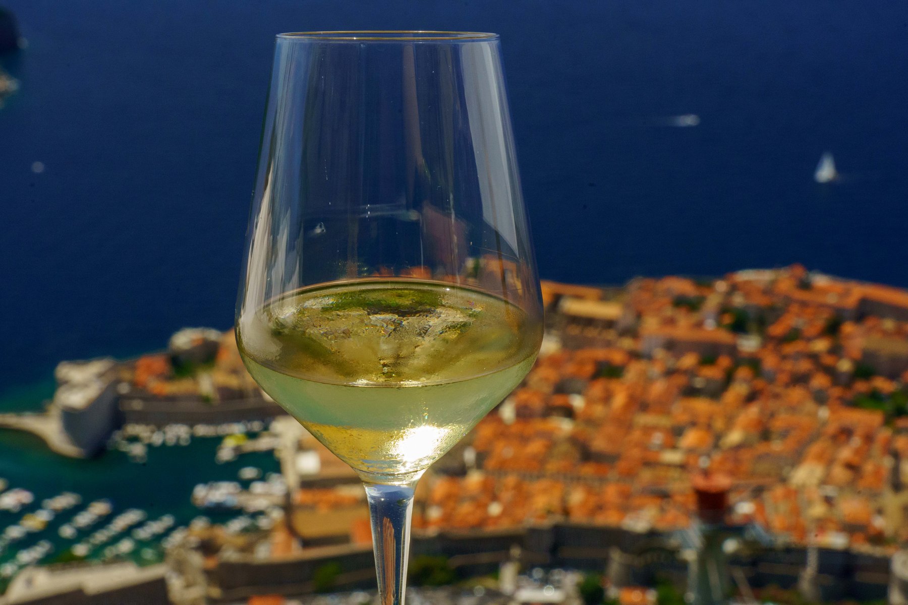 A glass of wine on a patio overlooking Dubrovnik's old town