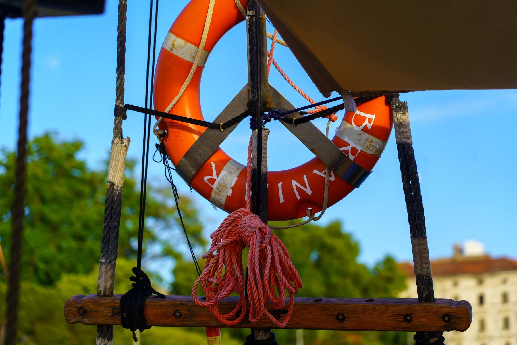 Life ring hanging on a wooden sailboat in the evening