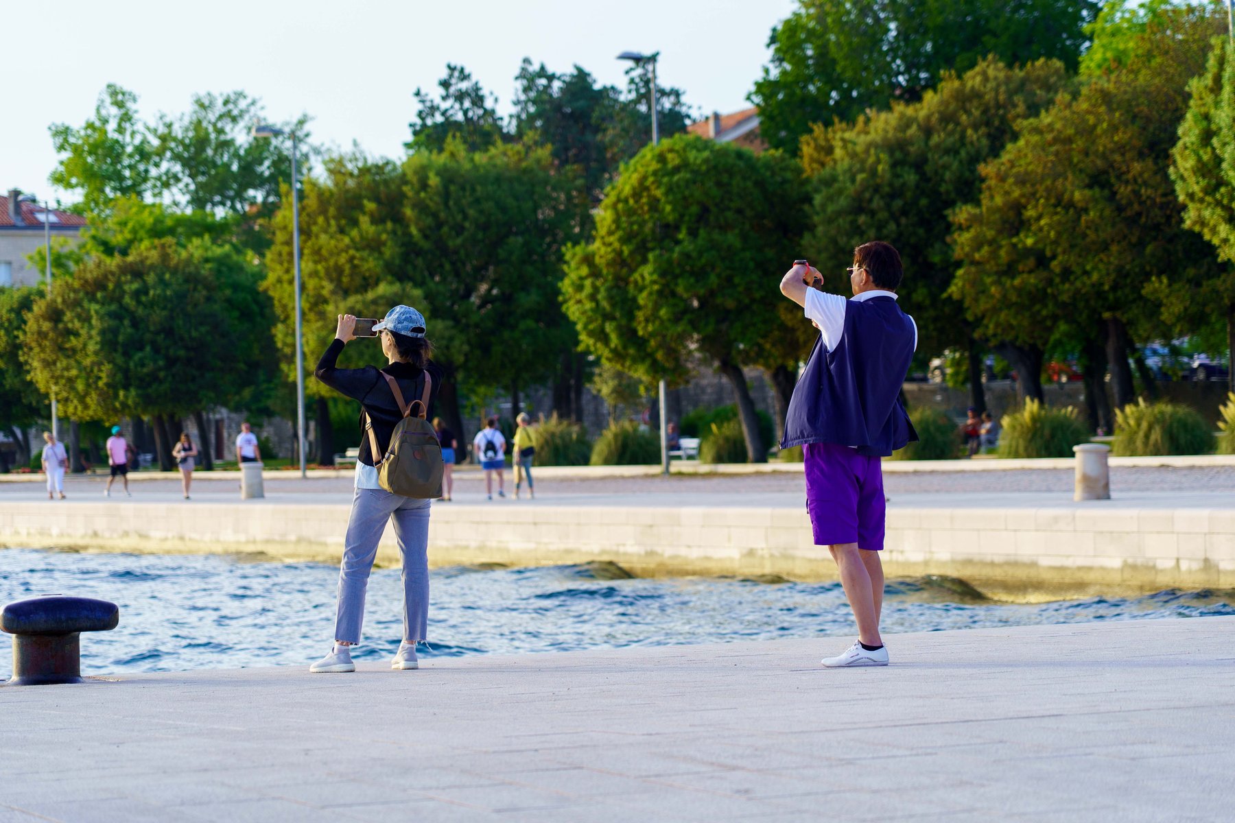 People photographing golden hour along the Zadar waterfront
