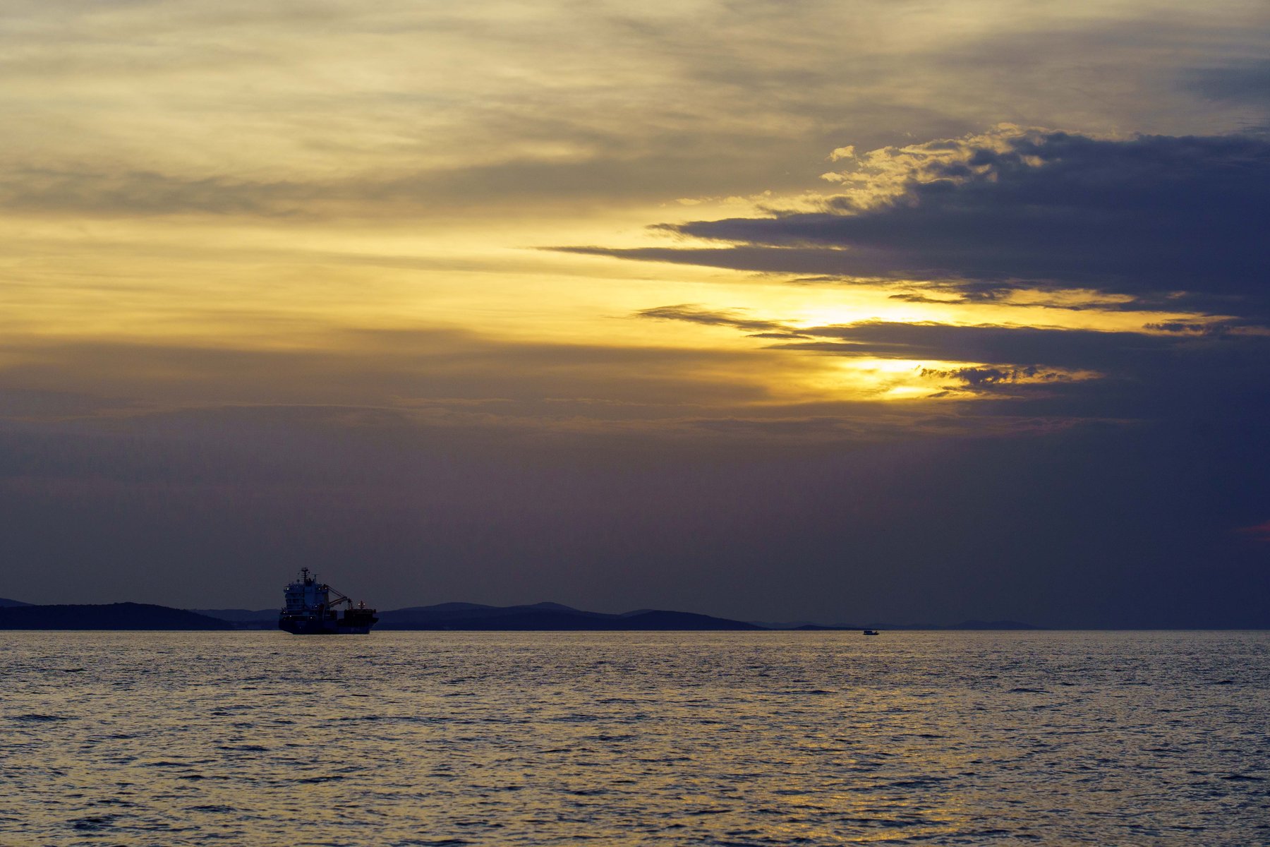 Sunset over the Adriatic with a ship silhouetted on the horizon