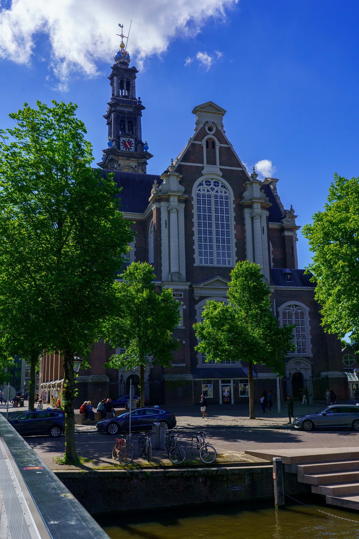 The Westerkerk tower seen across an Amsterdam canal
