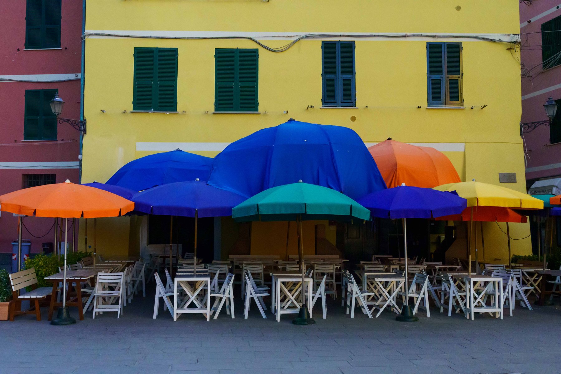 Umbrellas shading tables in the piazza at Vernazza