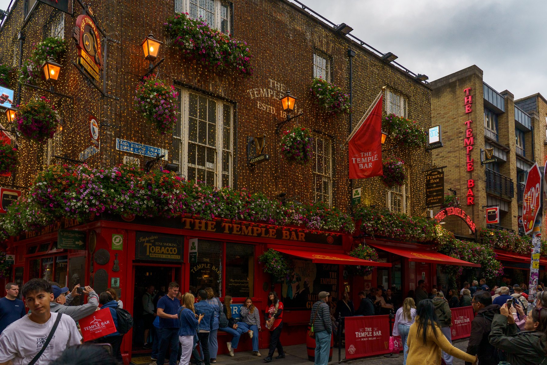 String lights and flower baskets along Temple Bar in Dublin