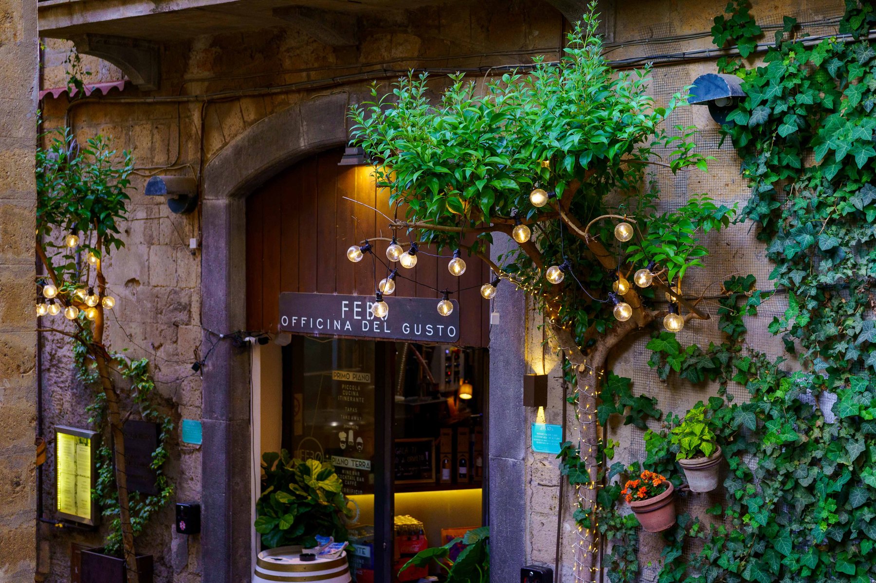 The entrance to Febo Officina del Gusto, lit up in the evening