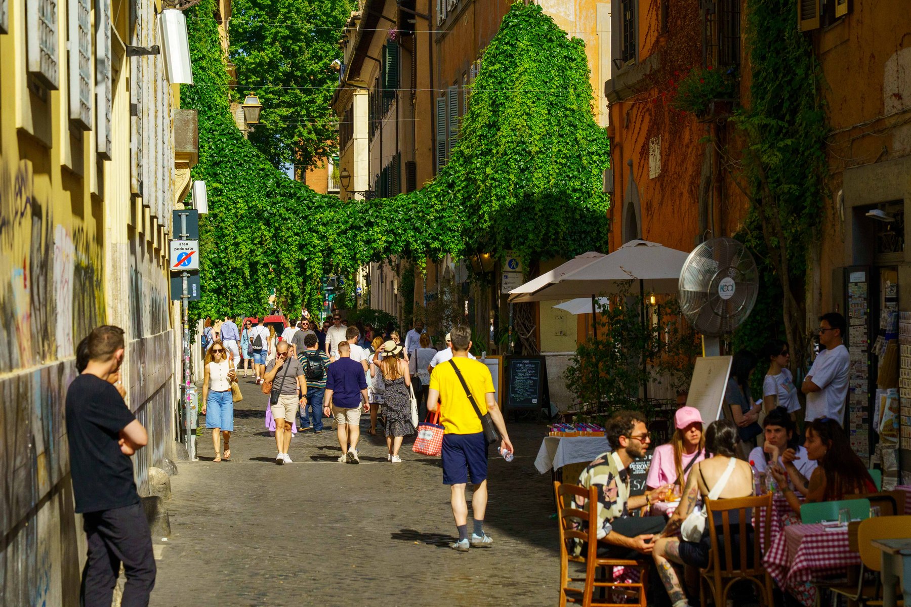 An ivy-covered pedestrian alley in Trastevere, Rome