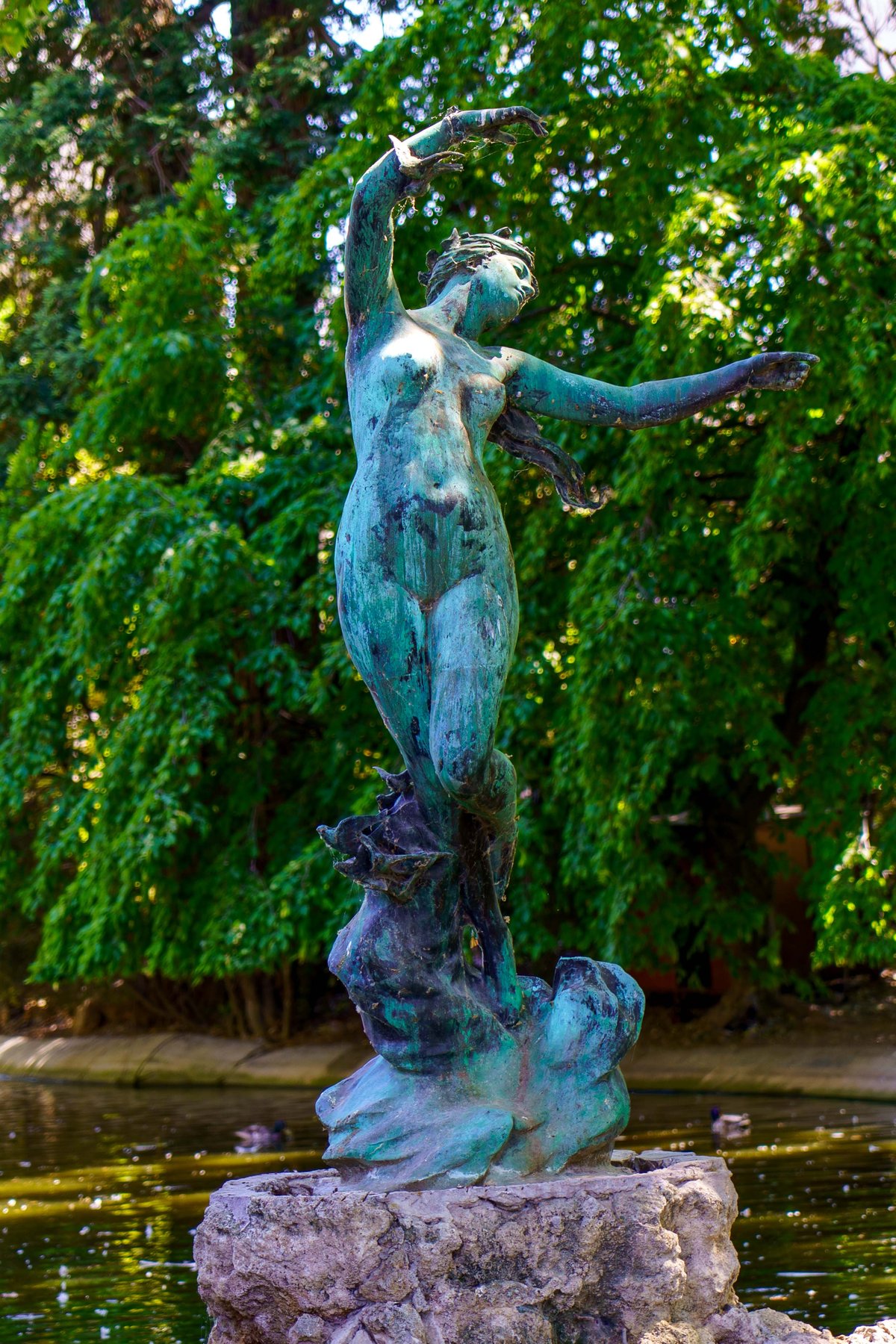 The bronze Venus aux Hirondelles rising from a pond in the Rocher des Doms gardens in Avignon