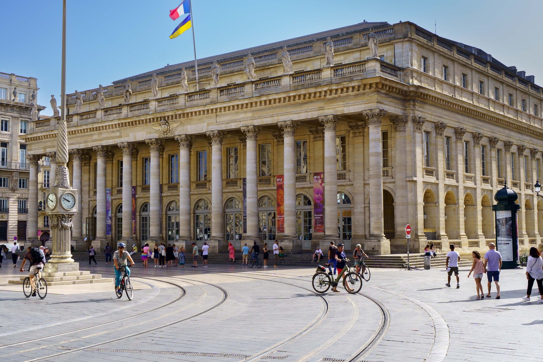 The Grand Theatre de Bordeaux with cyclists crossing the Place de la Comedie