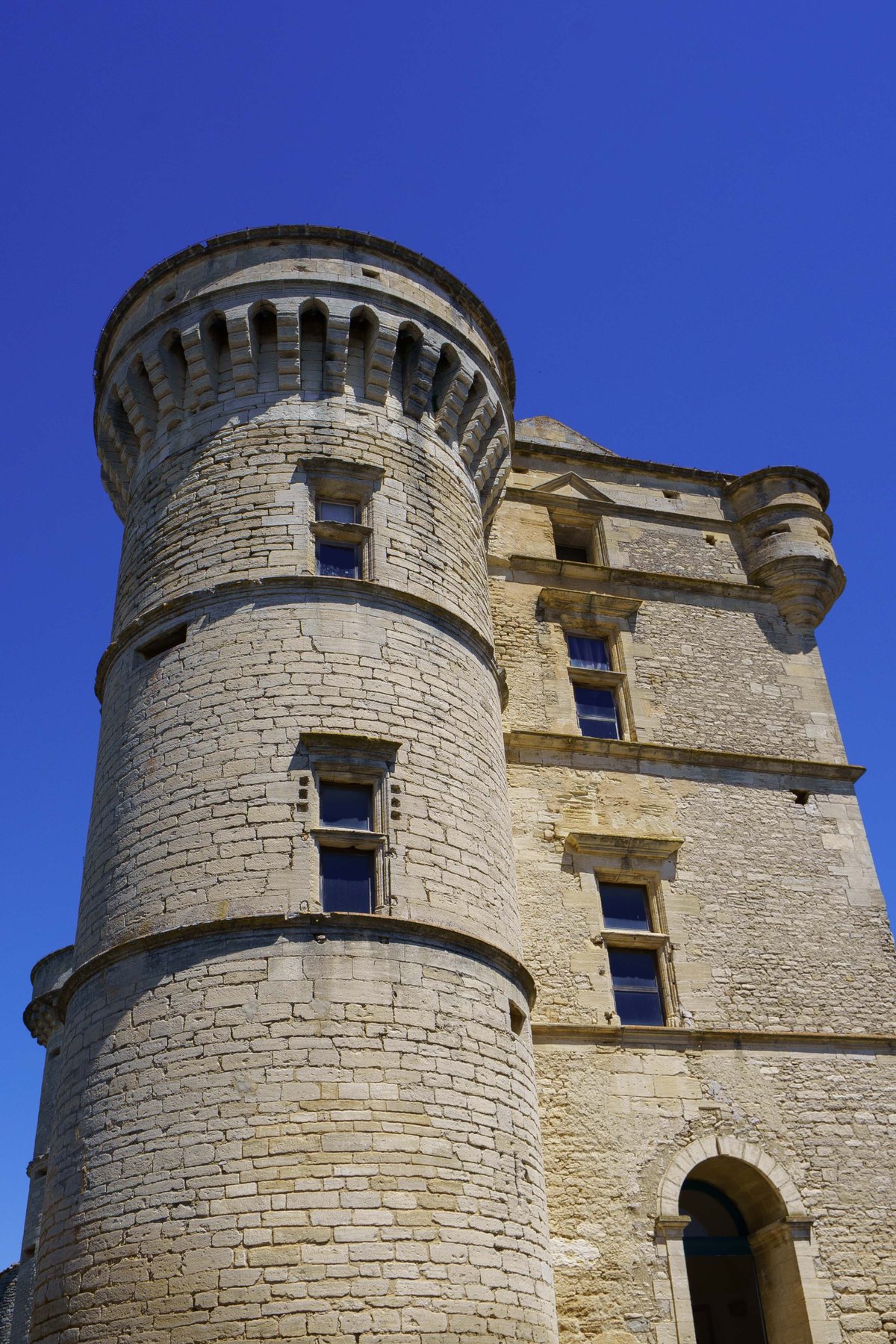 A round tower of the Chateau de Gordes crowned with machicolations