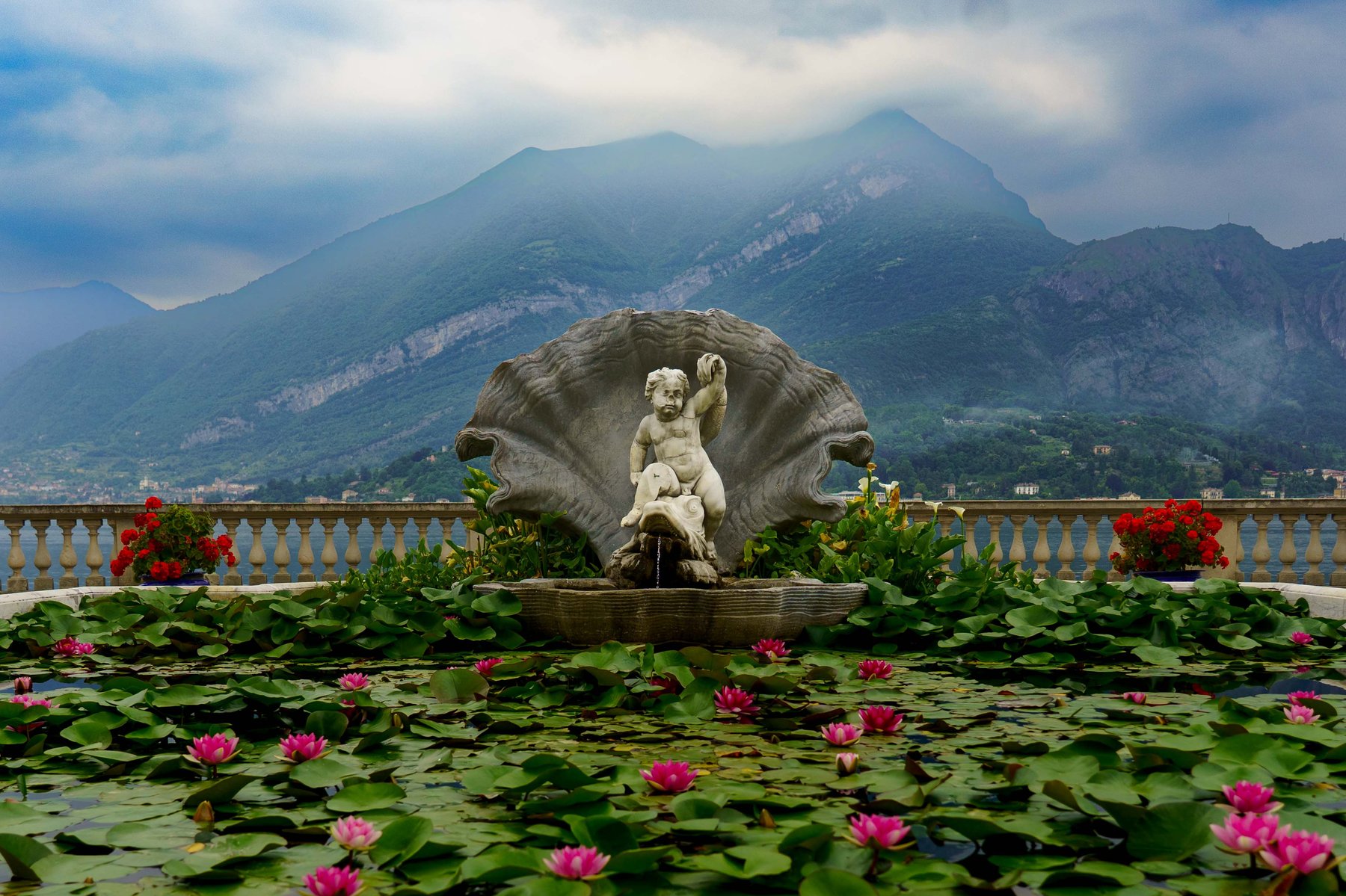 A cherub fountain amid water lilies in the gardens of Villa Melzi d'Eril