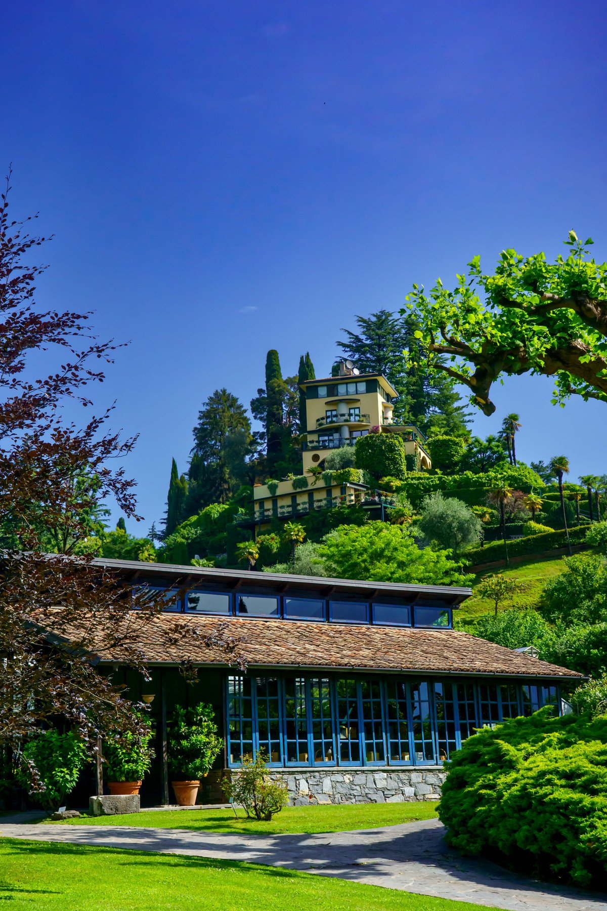 A hilltop villa above Villa Carlotta's grounds, framed by greenery