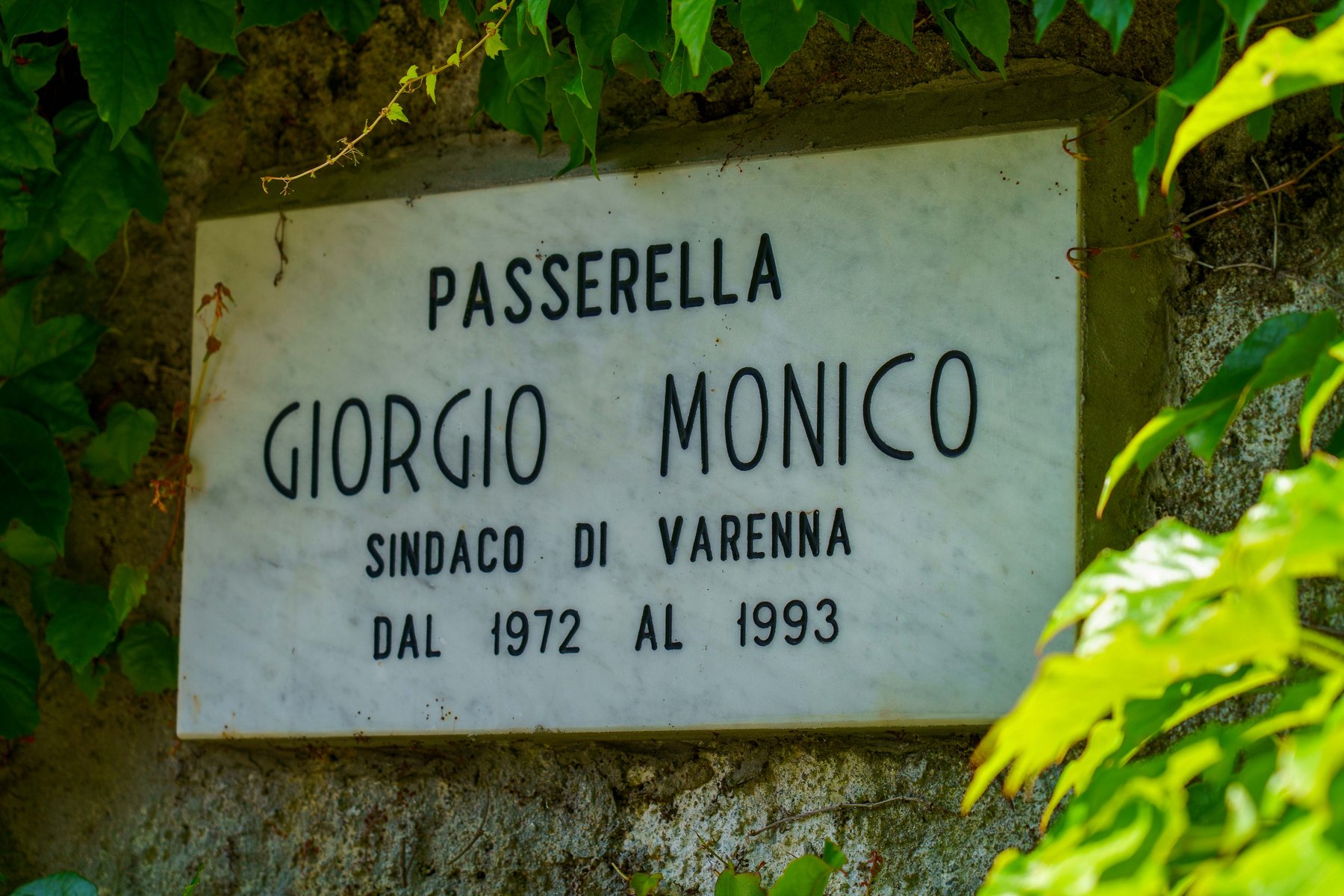 A plaque honoring Giorgio Monico, mayor of Varenna, on the footbridge that bears his name