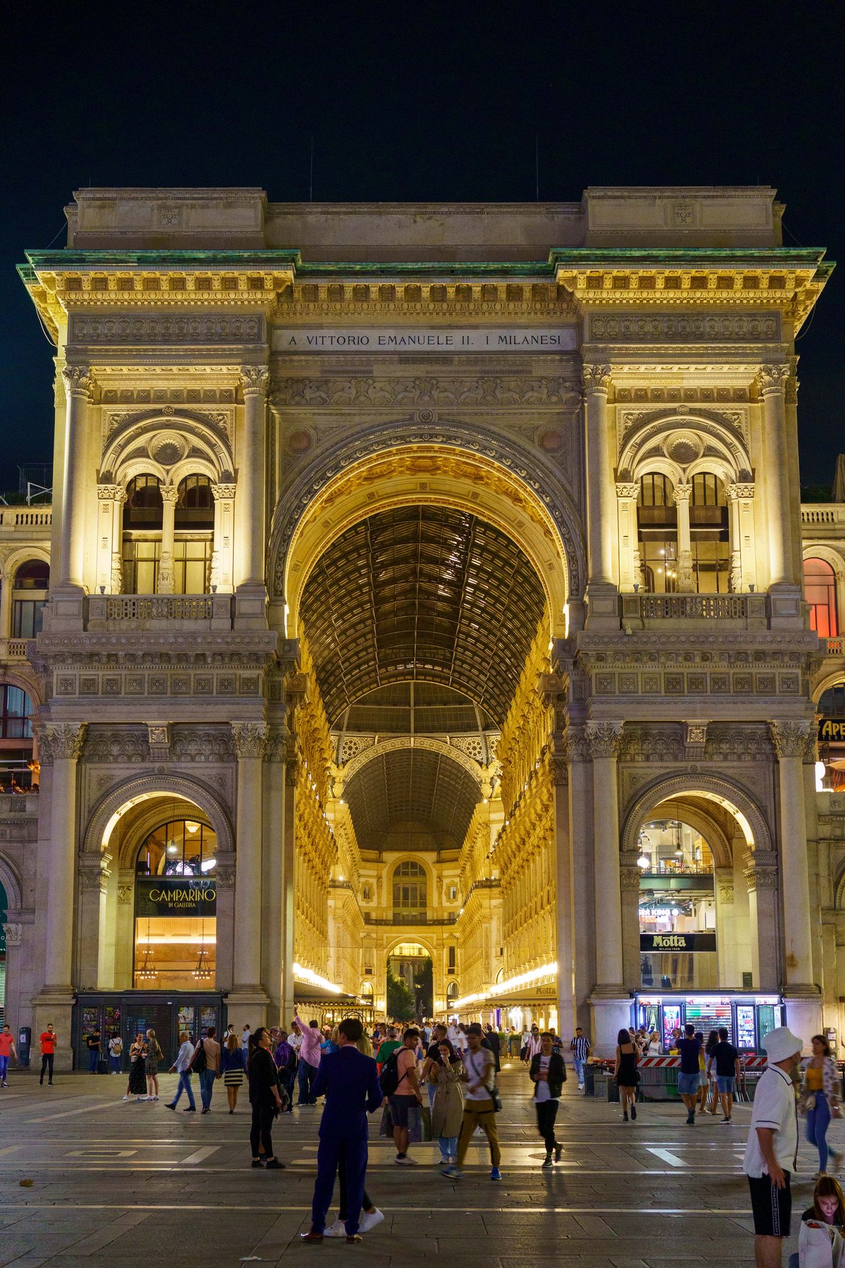 The entrance arch to the Galleria Vittorio Emanuele II in Milan lit up at night