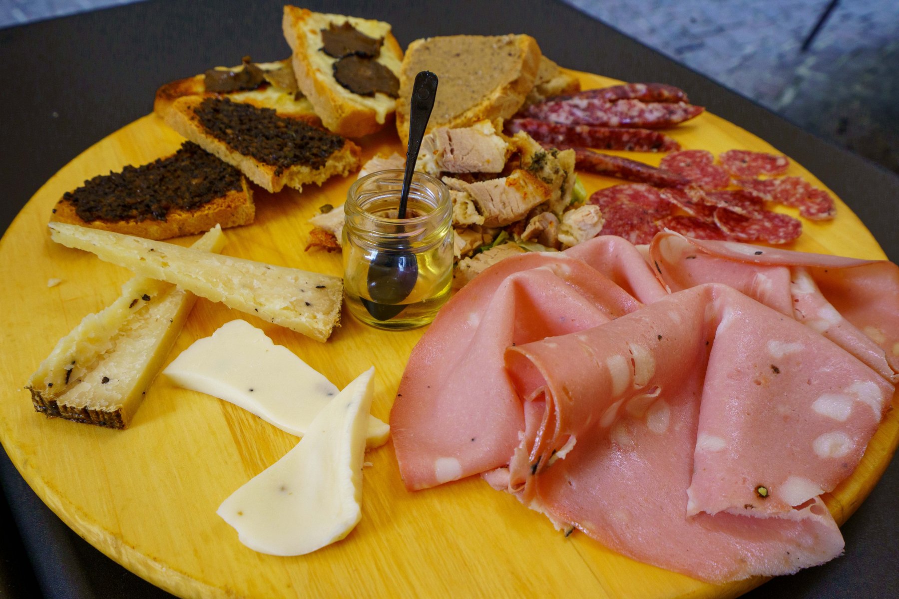 A board of truffle crostini, cured meats, and local cheeses in Orvieto
