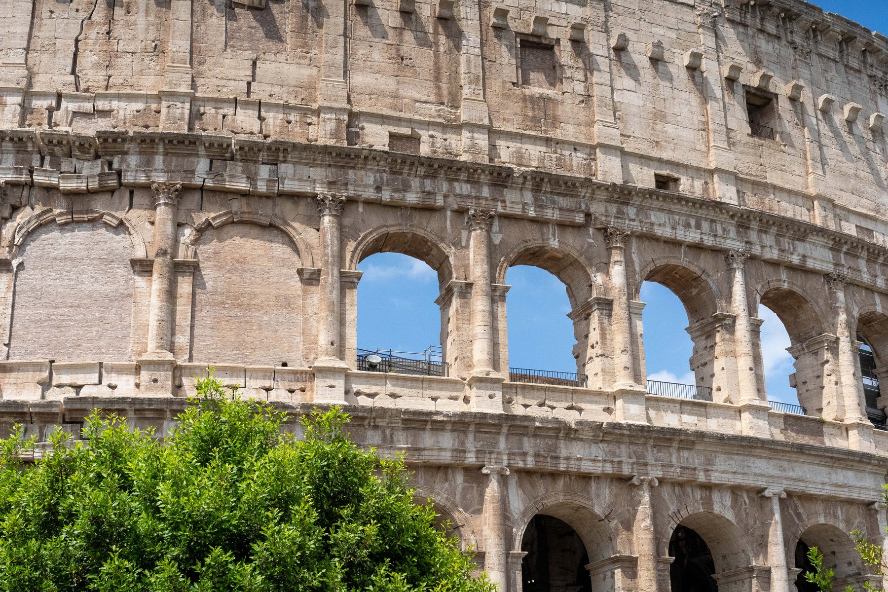 A close-up of the Colosseum's weathered stone arches in Rome
