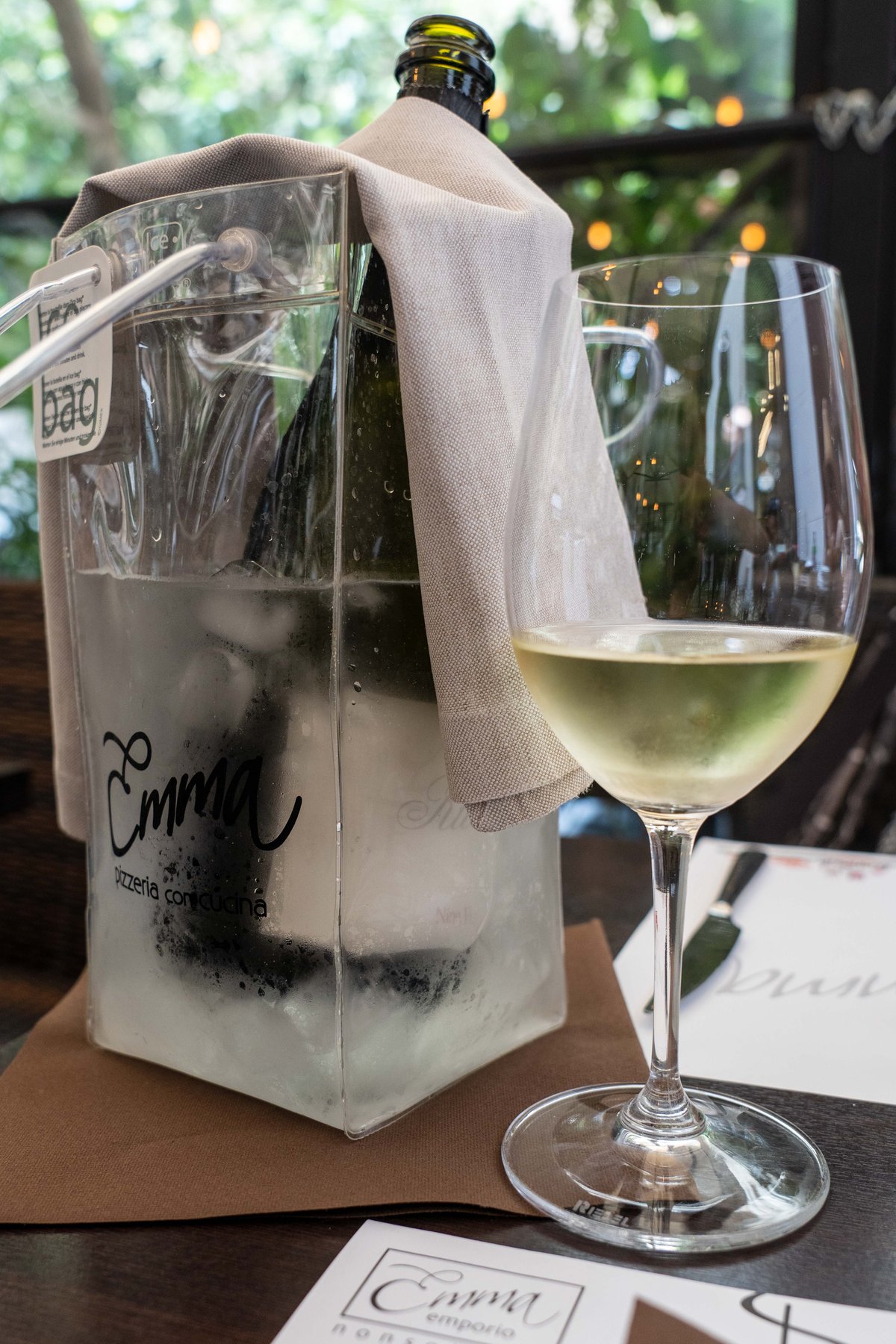 A glass of white wine chilling table-side at Emma, a Roman pizzeria