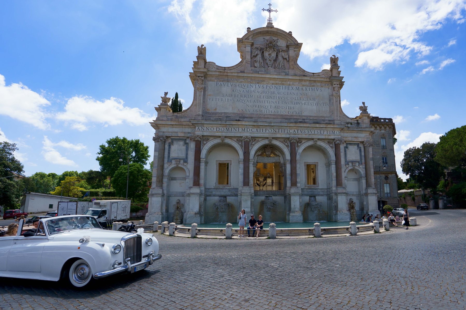 The Fontana dell'Acqua Paola on the Janiculum Hill in Rome, with a vintage wedding car parked below
