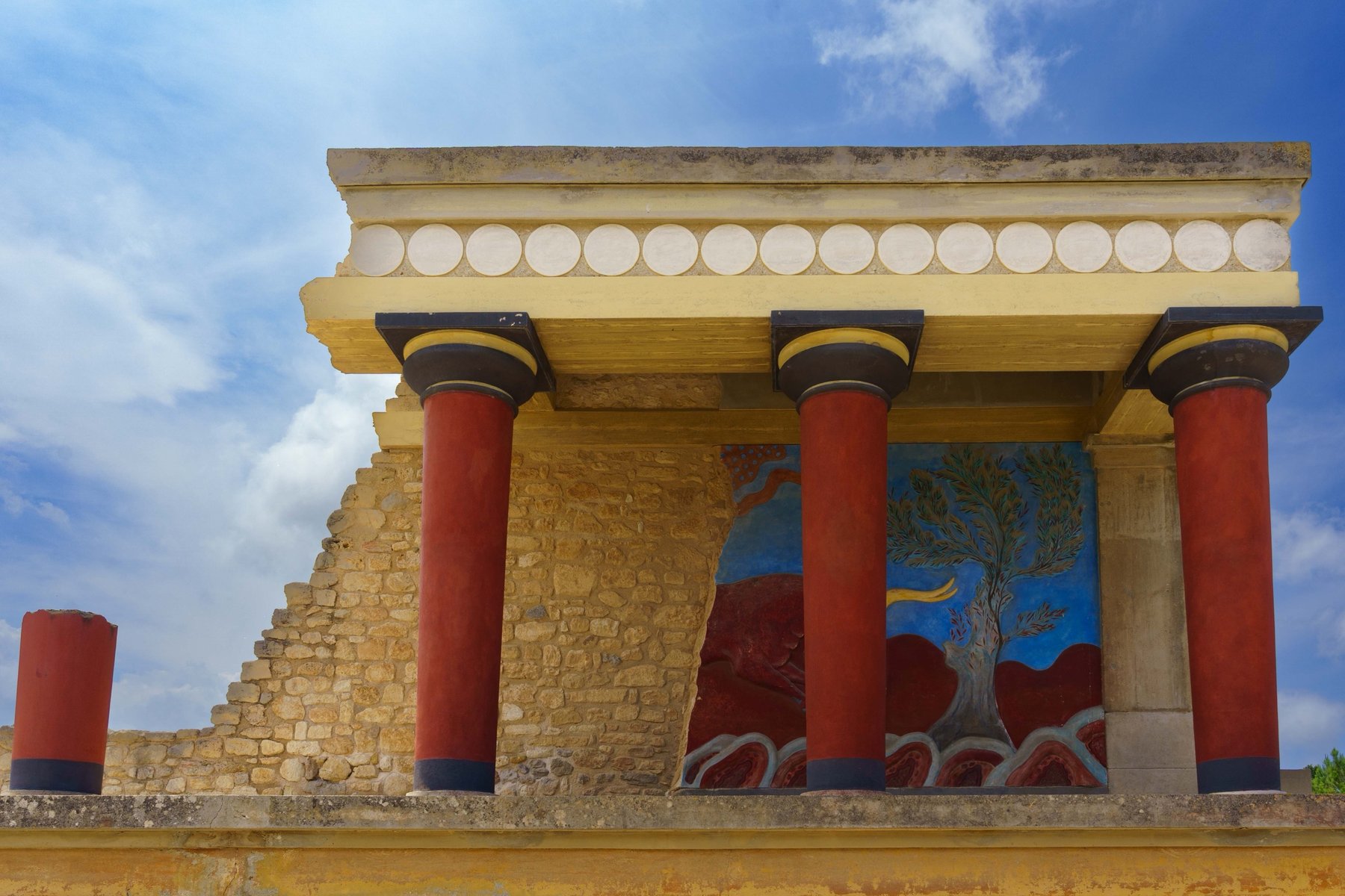 The restored red columns and reconstructed frescoes of the Palace of Knossos