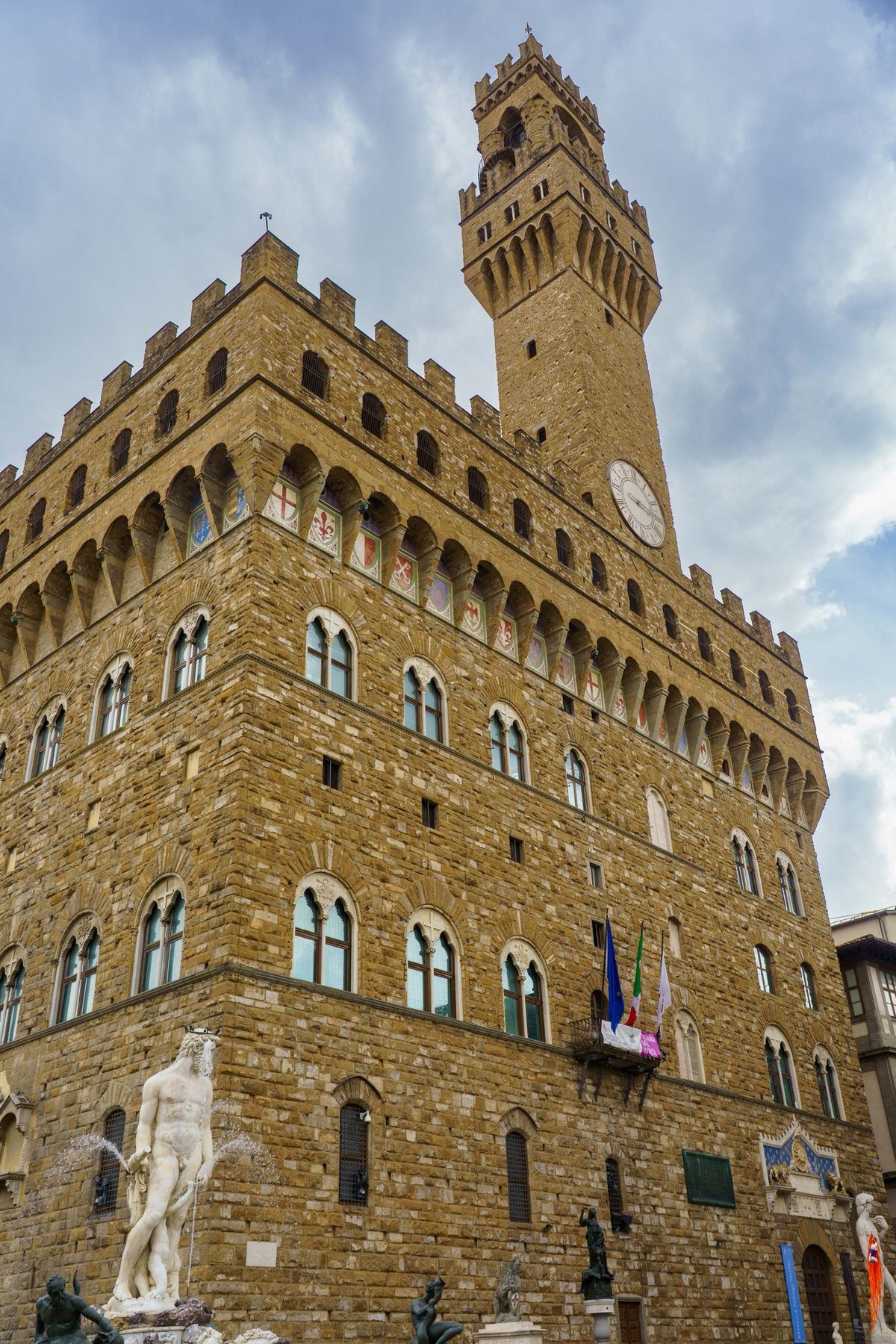 Palazzo Vecchio's fortress tower rising above the Fountain of Neptune in Florence