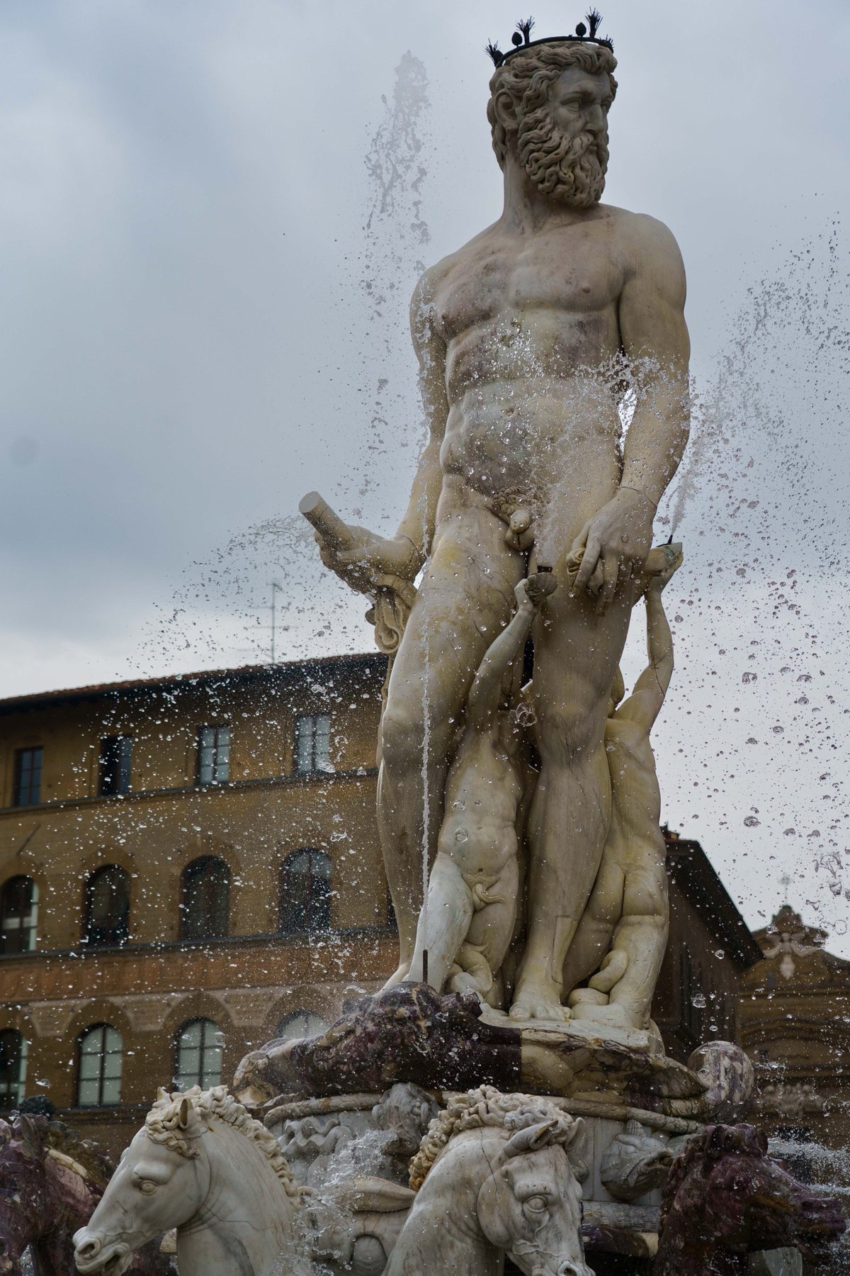 A close-up of the crowned, bearded Neptune statue at the fountain in Piazza della Signoria