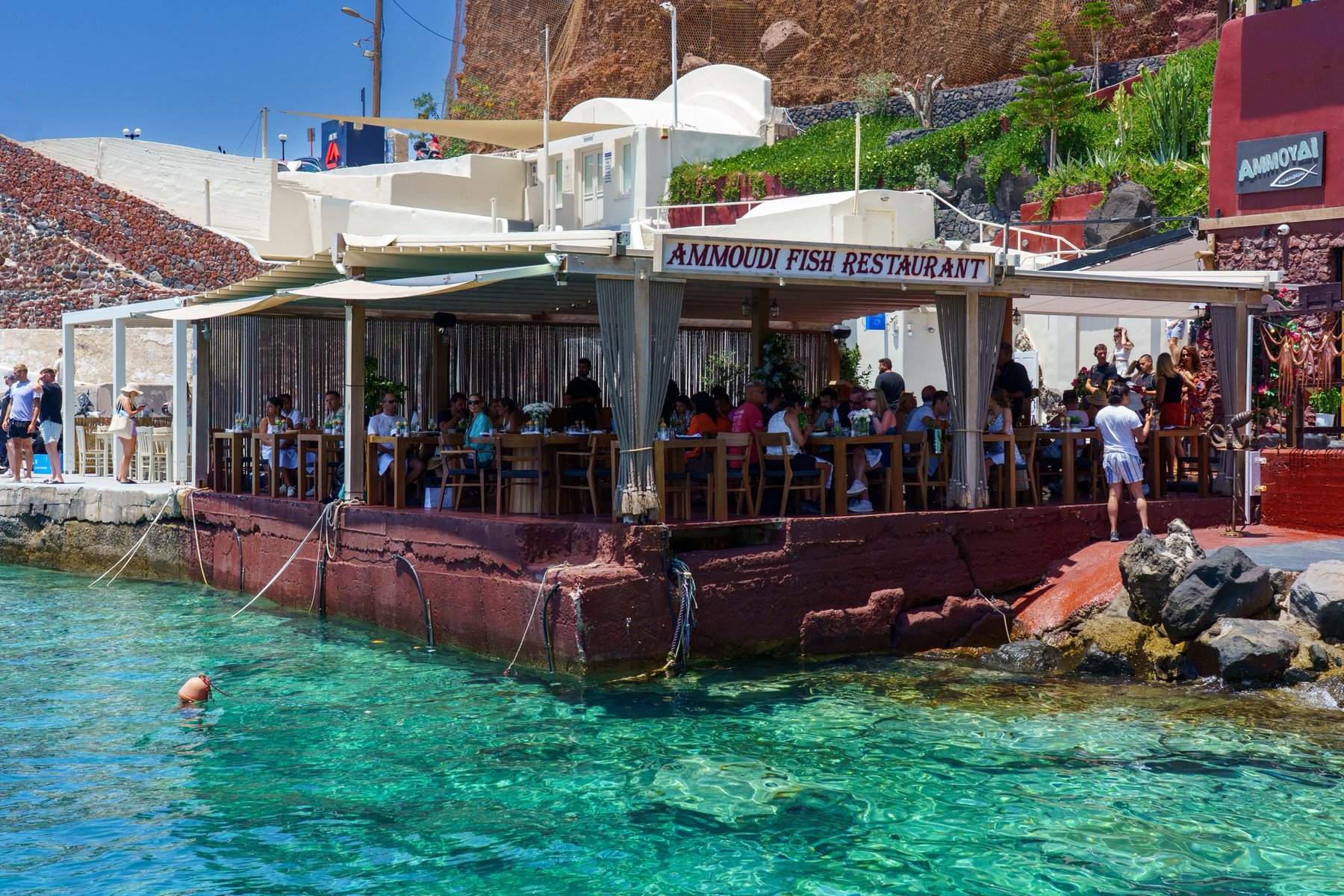 Ammoudi Fish Tavern built out over the clear water of Ammoudi Bay in Santorini