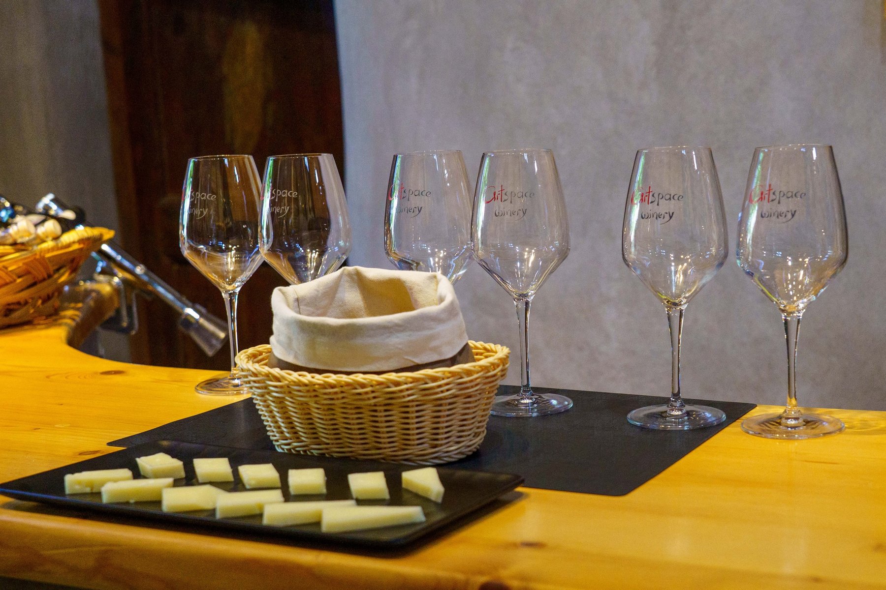 A wine tasting flight at Artspace Winery with local cheese in Santorini