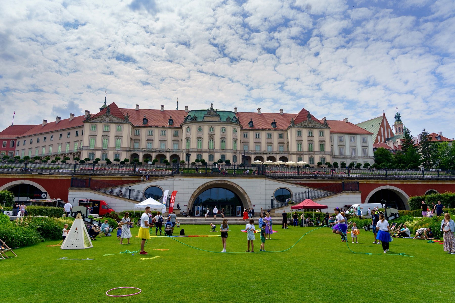 The Royal Castle overlooking its gardens, with a lively lawn below in Warsaw
