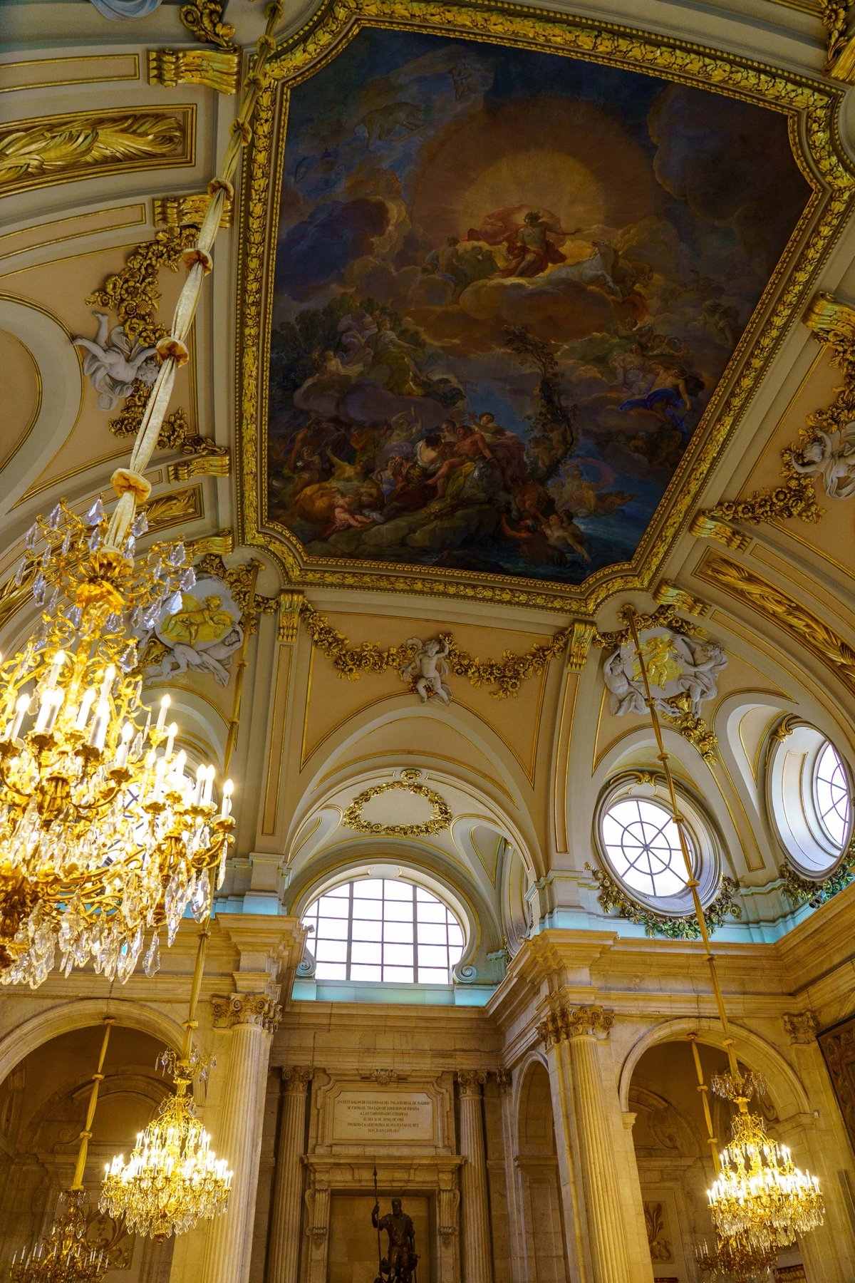 A gilded ceiling fresco inside the Royal Palace of Madrid