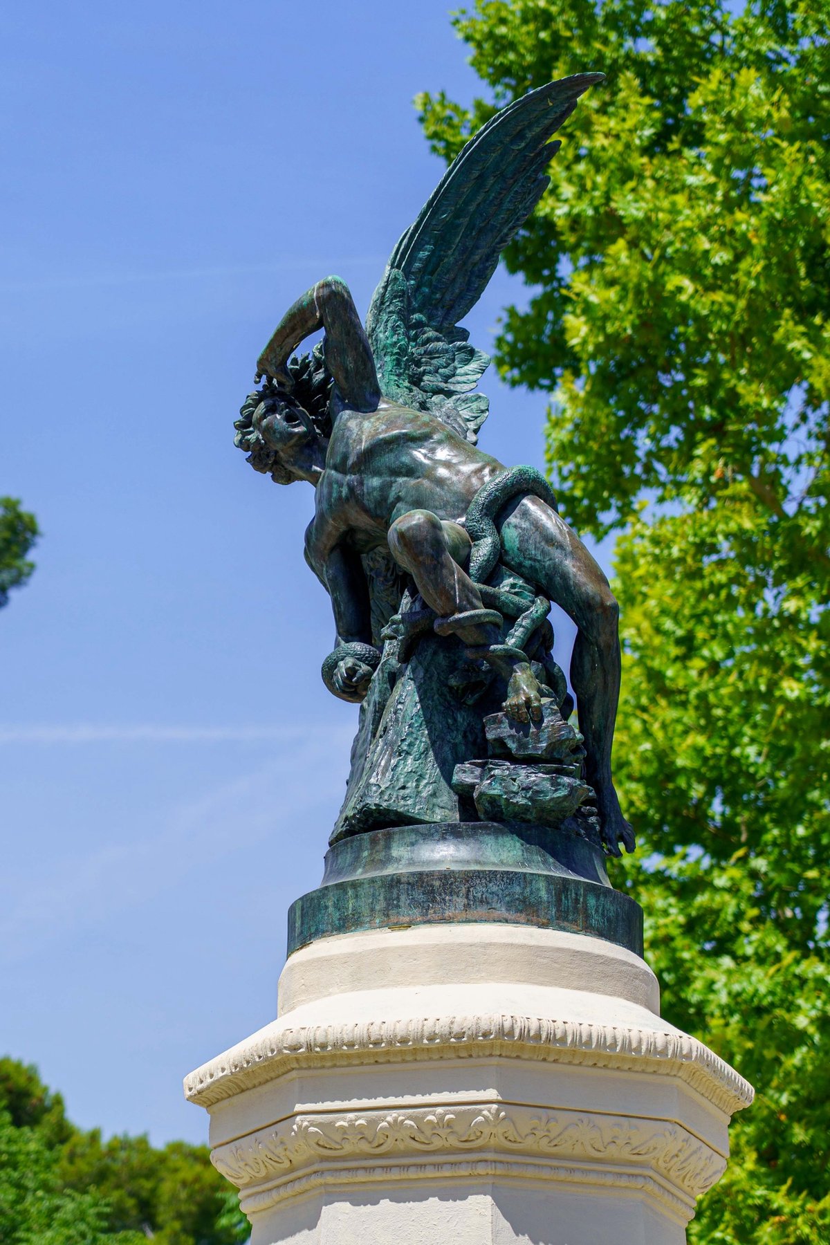 The Fallen Angel fountain, a bronze statue of a winged devil figure, in Retiro Park