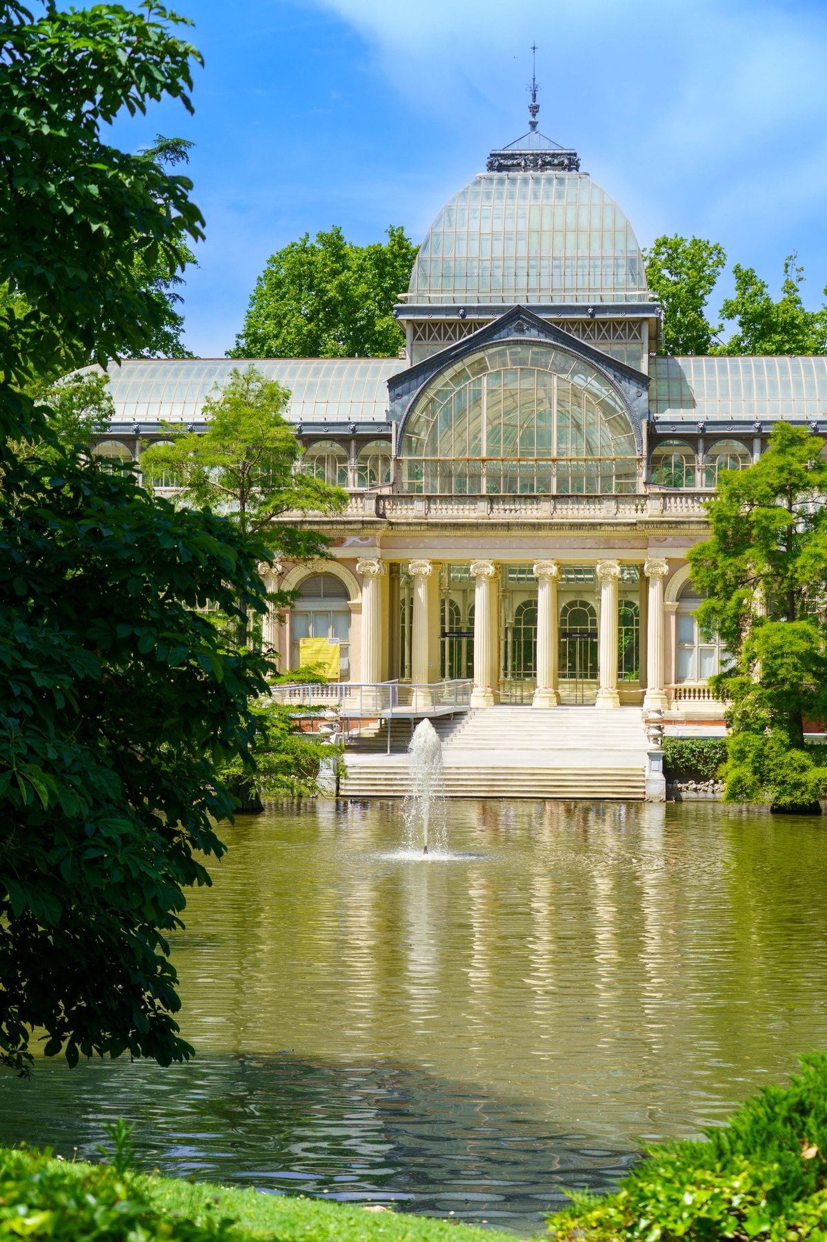 The Palacio de Cristal reflected in its pond in Retiro Park
