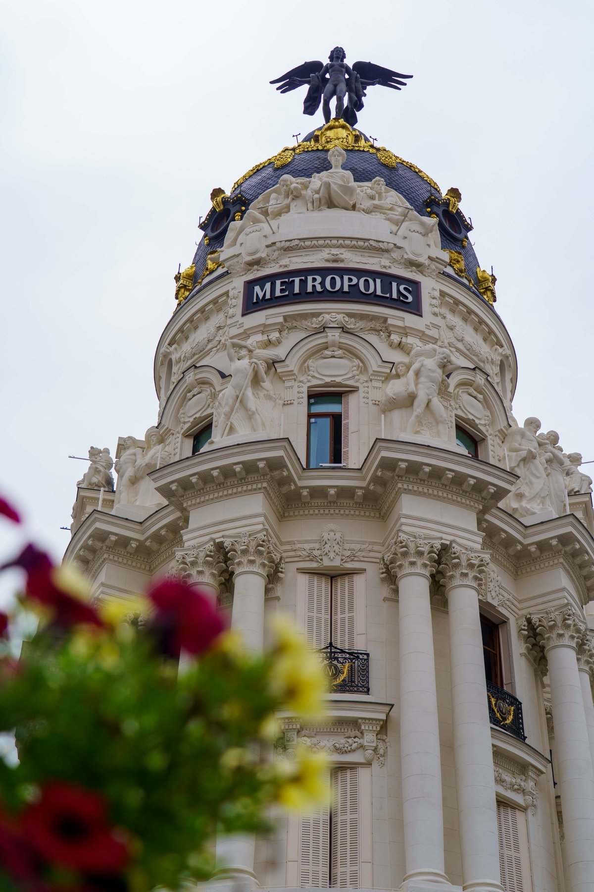 The winged bronze statue crowning the dome of the Metropolis Building in Madrid