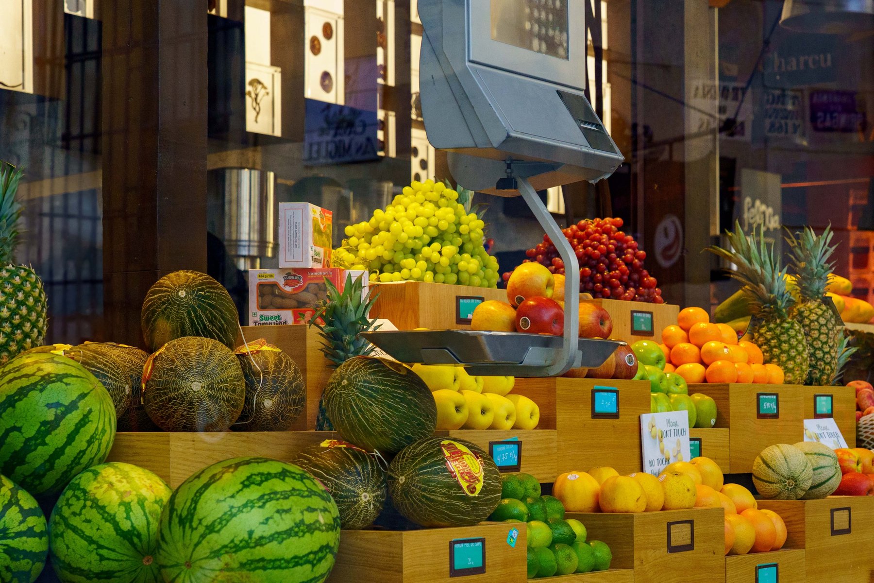 A produce stall overflowing with fruit at Mercado de San Miguel in Madrid