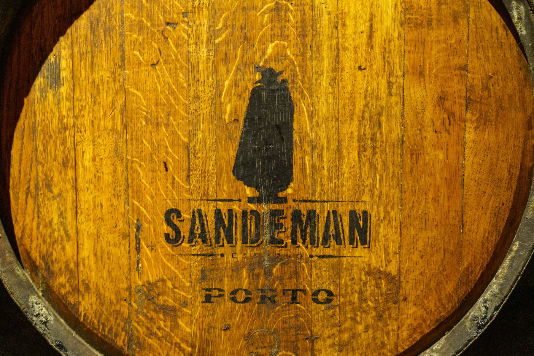 A wooden Sandeman port barrel stamped with the brand's silhouetted logo