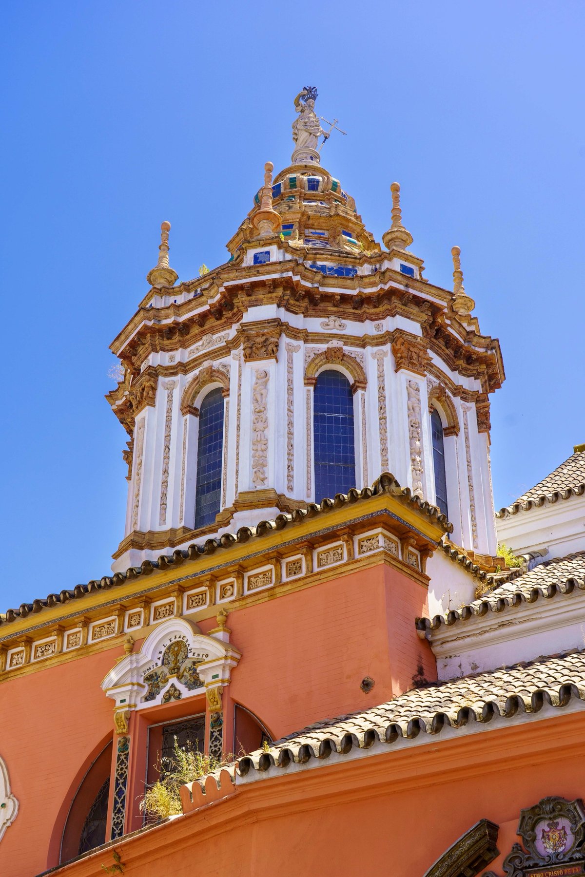 The Baroque bell tower of Iglesia de San Pedro topped with a statue