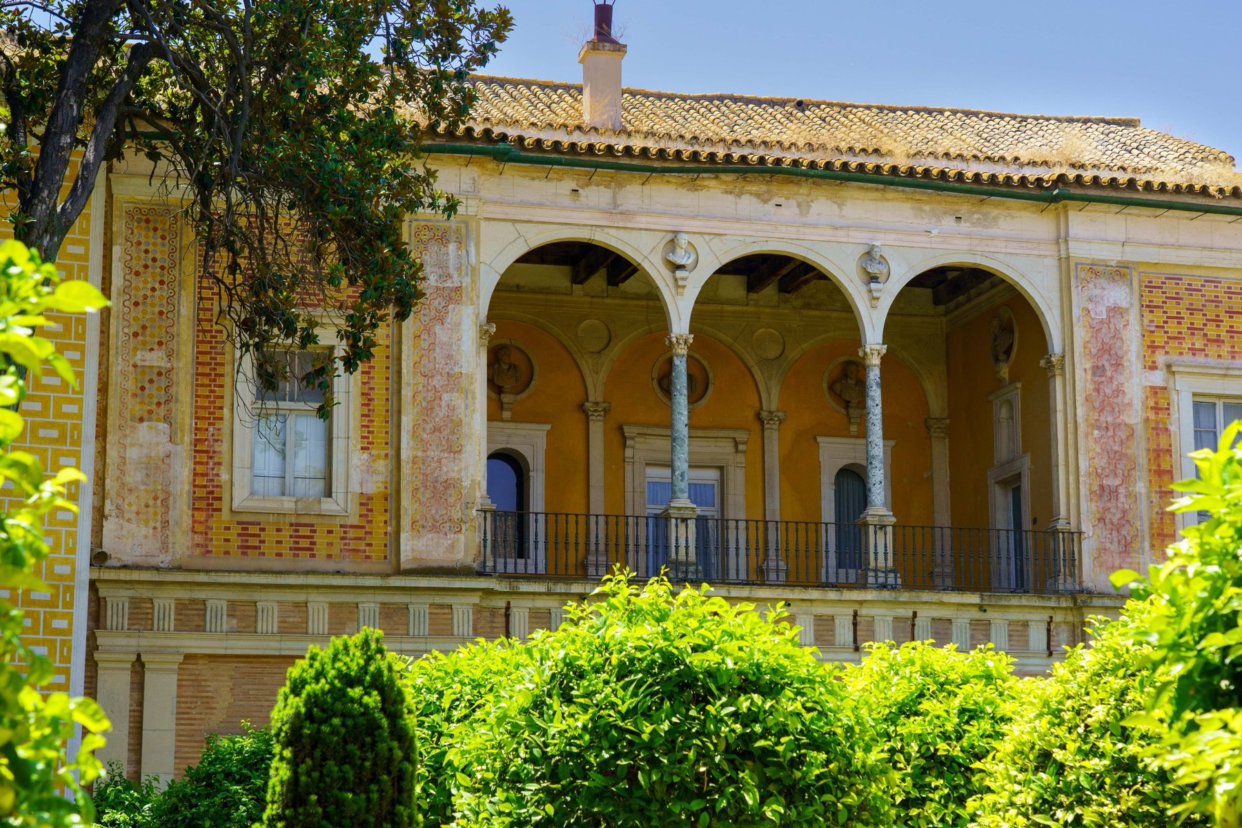 An upper-story loggia at Casa de Pilatos lined with classical busts