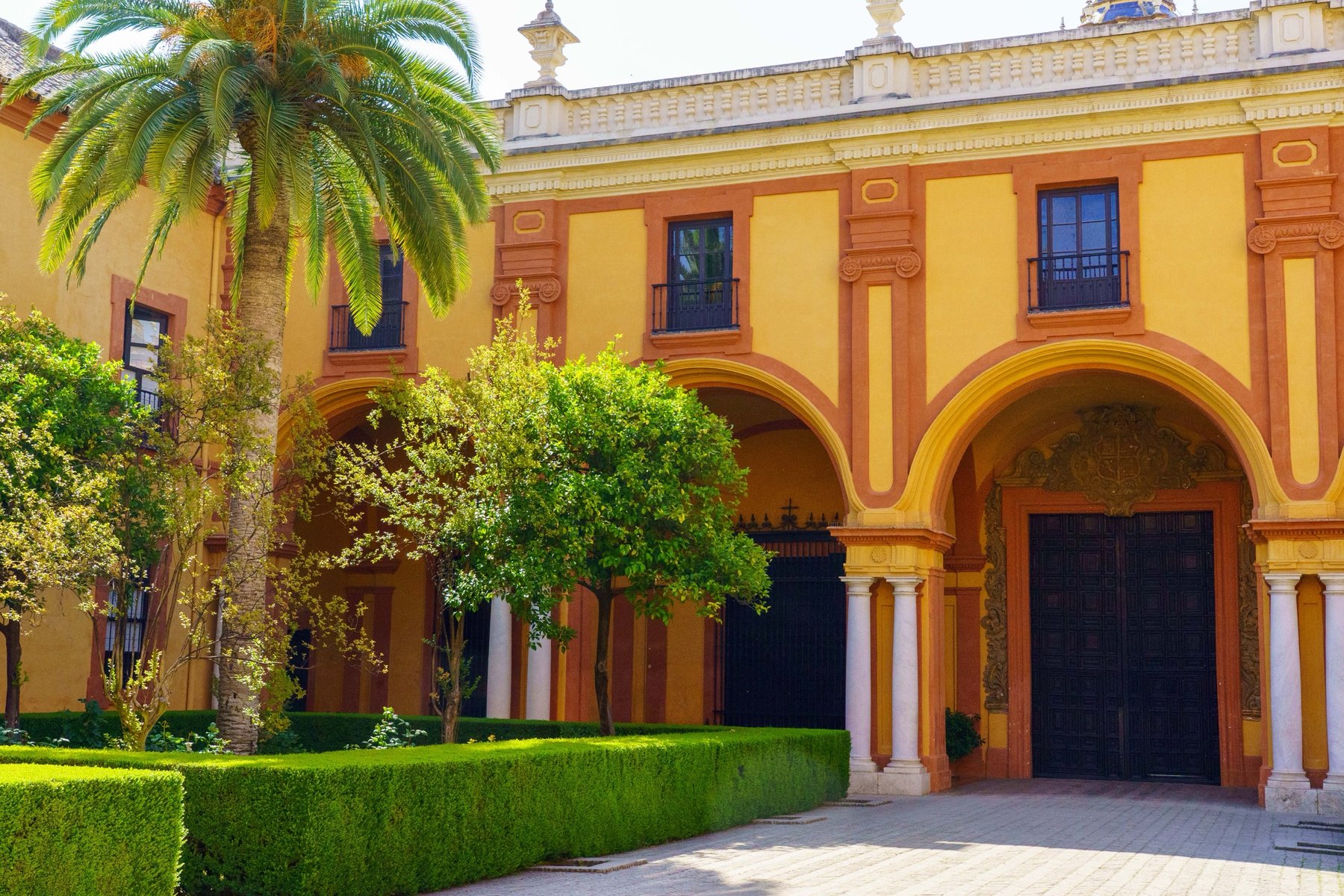 An archway and courtyard at the Real Alcázar in Seville