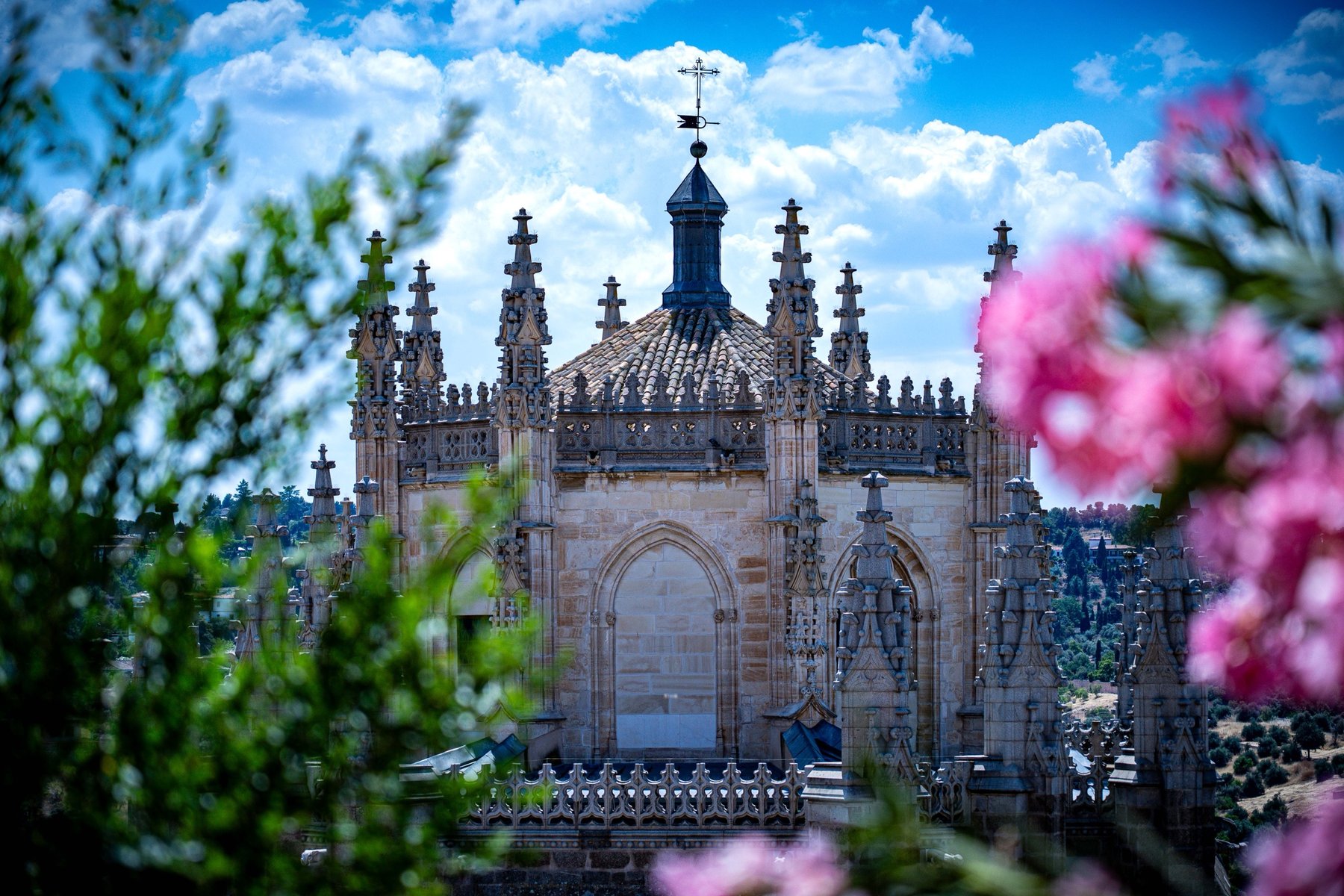 A Gothic chapel apse of the Cathedral of Toledo framed by blooming oleander