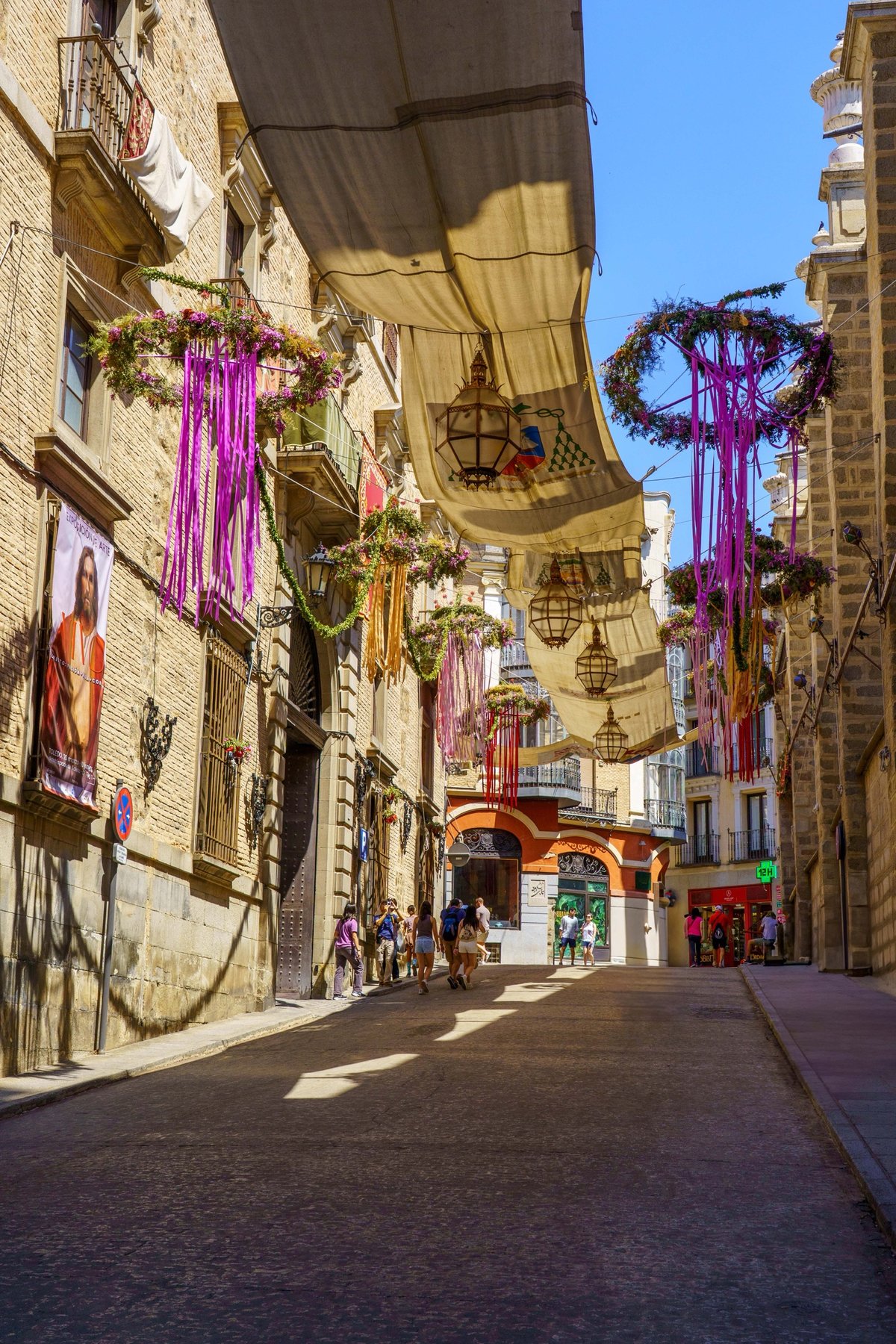 A Toledo street canopied with fabric awnings and floral decorations for Corpus Christi